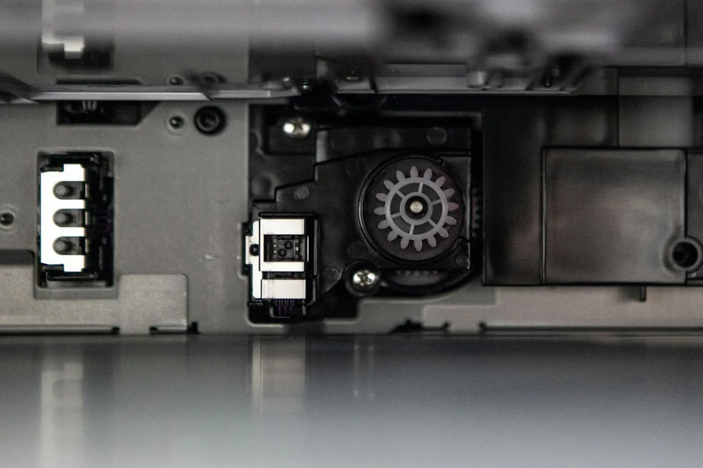 Inside a printer, showing gears and the paper feed mechanism